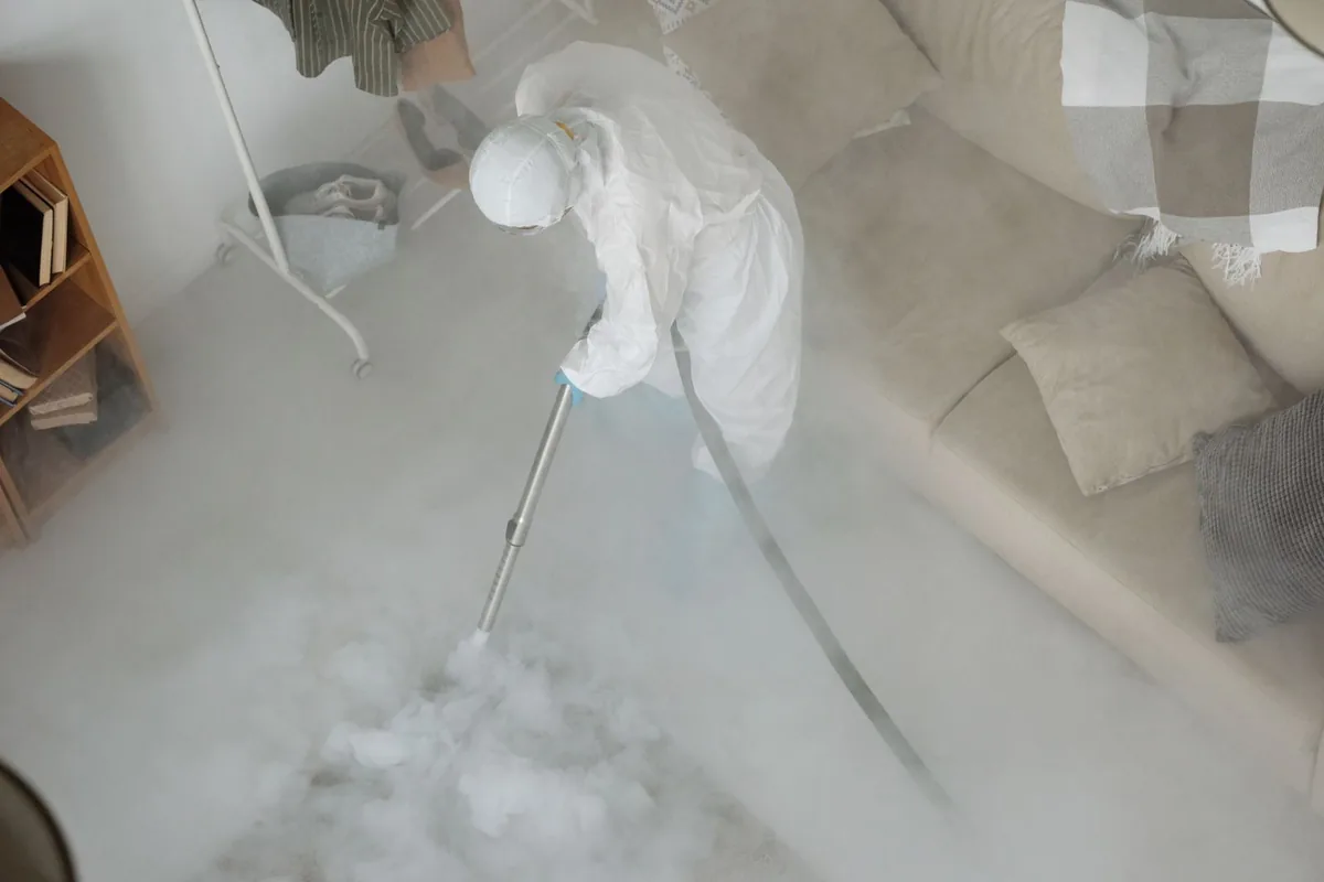 Biohazard cleanup technician in protective equipment, Lee, MA